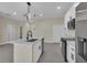 Open concept kitchen with island, modern lighting, and stainless steel appliances at 1819 Carr St, Deland, FL 32720