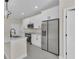 Modern kitchen with white cabinetry, stainless steel refrigerator and built-in microwave at 1819 Carr St, Deland, FL 32720