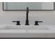 Modern bathroom sink with black faucet and white countertop at 1819 Carr St, Deland, FL 32720