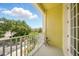 Balcony with charming view of community landscaping and sunny skies at 1845 Common Way Rd # 28-206, Orlando, FL 32814