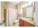 Bathroom with a single vanity, cabinet storage and shower with curtain at 1845 Common Way Rd # 28-206, Orlando, FL 32814