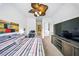 Bedroom with ceiling fan, tv and and modern decor at 1845 Common Way Rd # 28-206, Orlando, FL 32814