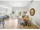 Open-concept dining area with wood floors and access to the outdoor space at 1845 Common Way Rd # 28-206, Orlando, FL 32814