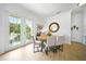 Open dining area with table setting and bright light from the glass paneled doors at 1845 Common Way Rd # 28-206, Orlando, FL 32814