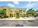 Charming two-story yellow townhome features individual garages and manicured landscaping at 1845 Common Way Rd # 28-206, Orlando, FL 32814