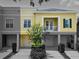 Townhouse exterior with charming balcony and manicured landscaping at 1845 Common Way Rd # 28-206, Orlando, FL 32814