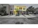 Charming townhome features a covered balcony, yellow and gray exterior, and a one-car garage for convenient parking at 1845 Common Way Rd # 28-206, Orlando, FL 32814