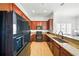 The kitchen features warm wooden cabinets, modern appliances and ample counter space at 1845 Common Way Rd # 28-206, Orlando, FL 32814