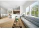 Bright, open living space featuring a modern sofa and view into the kitchen area at 1845 Common Way Rd # 28-206, Orlando, FL 32814