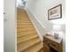 Bright staircase with wooden steps and white railing at 1845 Common Way Rd # 28-206, Orlando, FL 32814