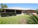 Spacious backyard with a well-maintained lawn, mature hedges, and screened-in patio at 1889 Eden Dr, Deltona, FL 32725