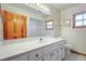 Bathroom featuring a white vanity, large mirror, and shower behind a wall at 1889 Eden Dr, Deltona, FL 32725