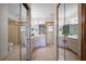 Spacious bathroom featuring tile floors, dual vanity, and mirrored closet doors at 1889 Eden Dr, Deltona, FL 32725