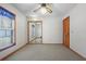 Bedroom with carpet, closet with mirror doors, a window, and a ceiling fan at 1889 Eden Dr, Deltona, FL 32725