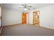 Main bedroom featuring carpet, ceiling fan, and ensuite bathroom at 1889 Eden Dr, Deltona, FL 32725