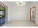 Spacious dining area with tile flooring, sliding glass doors, and an adjacent doorway at 1889 Eden Dr, Deltona, FL 32725