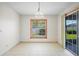 Bright dining room with tile floors, an orange-trimmed window, and sliding glass doors to the outside at 1889 Eden Dr, Deltona, FL 32725