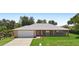 Charming single-story home with a brick facade, well-manicured lawn, and paved driveway at 1889 Eden Dr, Deltona, FL 32725
