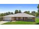 Well-maintained brick home with a lush green lawn and freshly painted garage door at 1889 Eden Dr, Deltona, FL 32725