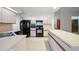 Bright kitchen with island, black appliances, white cabinets, and tile flooring at 1889 Eden Dr, Deltona, FL 32725