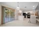 Kitchen featuring white cabinets, black appliances, tile flooring, island and glass doors at 1889 Eden Dr, Deltona, FL 32725