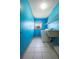 A well-lit laundry room featuring a utility sink, washer, dryer, and tile flooring at 1889 Eden Dr, Deltona, FL 32725