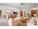 Inviting living space with tile floors, a ceiling fan, and kitchen bar seating at 1889 Eden Dr, Deltona, FL 32725