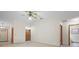 Spacious living room with neutral walls, tile flooring, and multiple doorways at 1889 Eden Dr, Deltona, FL 32725