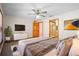 A view of the main bedroom showing a ceiling fan, tv, and ensuite bathroom at 1889 Eden Dr, Deltona, FL 32725