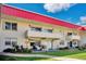Exterior building view with balconies and patios, red roof and lush landscaping at 2901 N Halifax Ave # 220, Daytona Beach, FL 32118