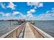Dock view featuring a wooden walkway, a covered sitting area on the water, and a beautiful skyline at 2901 N Halifax Ave # 220, Daytona Beach, FL 32118