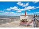 Waterfront view of a dock featuring a table, benches, umbrella, lounge chair, and beautiful views at 2901 N Halifax Ave # 220, Daytona Beach, FL 32118