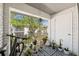 Charming balcony with various potted plants, a bicycle, and a view of the lush outdoor landscape at 2912 Plaza Terrace Dr # 2912, Orlando, FL 32803
