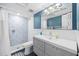 Updated bathroom featuring a walk-in shower with decorative tile and a gray vanity with modern fixtures at 2912 Plaza Terrace Dr # 2912, Orlando, FL 32803