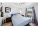 Well-lit bedroom with a queen-sized bed, ceiling fan, and hardwood flooring at 2912 Plaza Terrace Dr # 2912, Orlando, FL 32803
