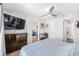 Cozy bedroom featuring hard wood floors, a ceiling fan, and a mounted television at 2912 Plaza Terrace Dr # 2912, Orlando, FL 32803