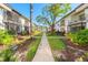 Landscaped courtyard with walking path between two buildings showcasing green space at 2912 Plaza Terrace Dr # 2912, Orlando, FL 32803