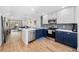 Modern kitchen featuring two-tone cabinets, stainless steel appliances, and open concept to living room at 2912 Plaza Terrace Dr # 2912, Orlando, FL 32803