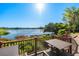 Lake view from wooden deck showing table, chairs and lush landscaping at 2912 Plaza Terrace Dr # 2912, Orlando, FL 32803