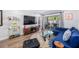 Inviting living room space features a large screen tv, an accent rug, and access to the back patio at 2912 Plaza Terrace Dr # 2912, Orlando, FL 32803