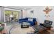 Comfortable living room area with blue sofa, glass table, access to an outdoor balcony and hardwood floors at 2912 Plaza Terrace Dr # 2912, Orlando, FL 32803