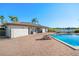 Exterior shot of the community pool, with patio, brick building, and lake view at 2912 Plaza Terrace Dr # 2912, Orlando, FL 32803