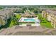 Aerial view of condo community featuring a central pool and common area, highlighting recreational amenities at 305 Terrace Ridge Cir # 305, Davenport, FL 33896