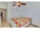 Well-lit bedroom boasting a ceiling fan and a closet door, offering ample storage and convenience at 305 Terrace Ridge Cir # 305, Davenport, FL 33896
