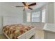 Bright bedroom featuring a white bed frame, ceiling fan, and natural light from windows, creating a relaxing ambiance at 305 Terrace Ridge Cir # 305, Davenport, FL 33896