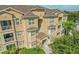 Multi-story condo featuring balconies and lush landscaping, offering a charming and desirable residential exterior at 305 Terrace Ridge Cir # 305, Davenport, FL 33896