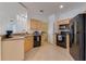 Well-lit kitchen with sleek black appliances and modern cabinetry at 305 Terrace Ridge Cir # 305, Davenport, FL 33896