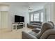 Inviting living area featuring stylish sofas and an electric fireplace at 305 Terrace Ridge Cir # 305, Davenport, FL 33896