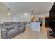 Inviting open-concept living area with contemporary furnishings, seamlessly connecting to the kitchen with black appliances at 305 Terrace Ridge Cir # 305, Davenport, FL 33896
