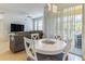 Bright living area featuring dining table and comfortable seating, illuminated by natural light and modern lighting fixtures at 305 Terrace Ridge Cir # 305, Davenport, FL 33896